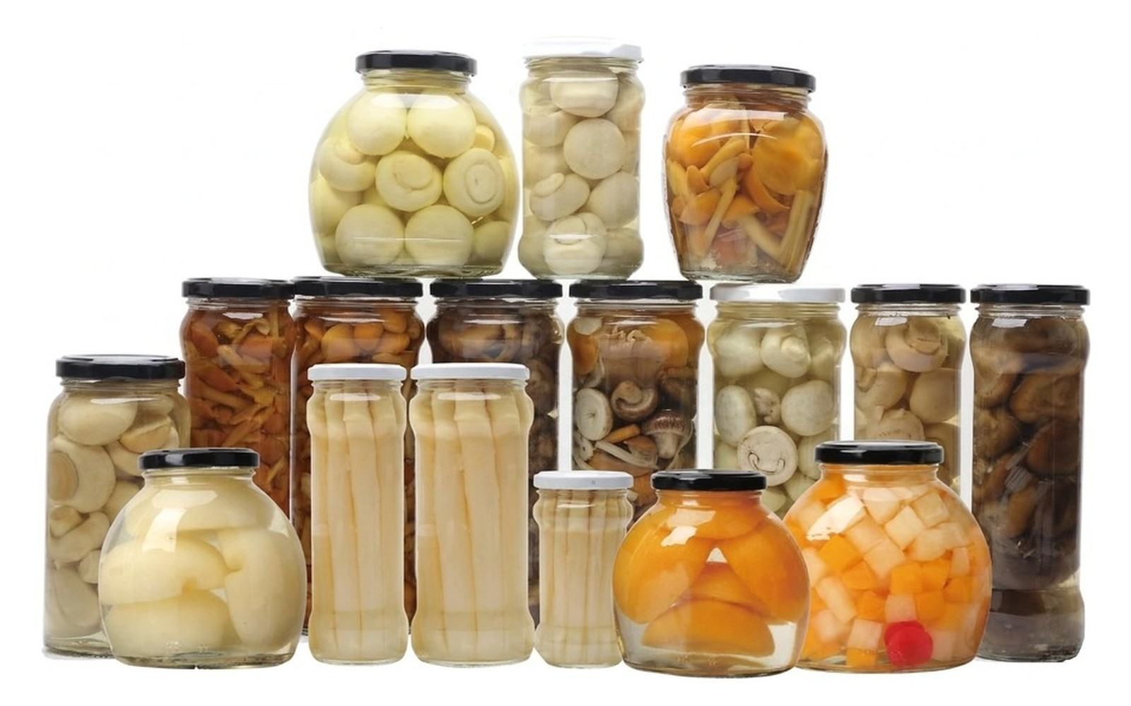Glass jars of pickled garlic, mushrooms, baby corn and fruit with twist-off lug caps